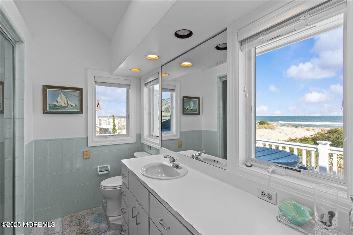 262 Sunset Lane Mantoloking, NJ 08738 - Photo 17 of 45 a bathroom with a sink a toilet and a large mirror