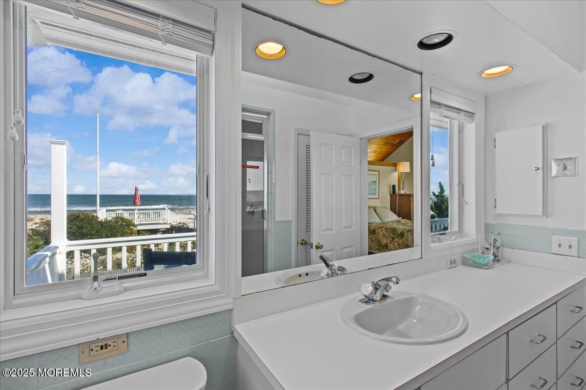 262 Sunset Lane Mantoloking, NJ 08738 - Photo 19 of 45 a bathroom with a sink and a mirror
