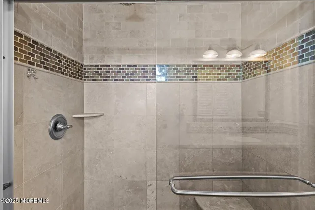 a bedroom with a large bed and flat tv screen