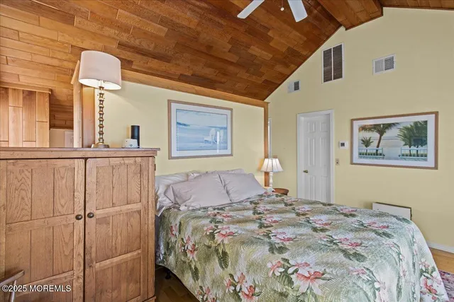 a bedroom with bed and wooden floor