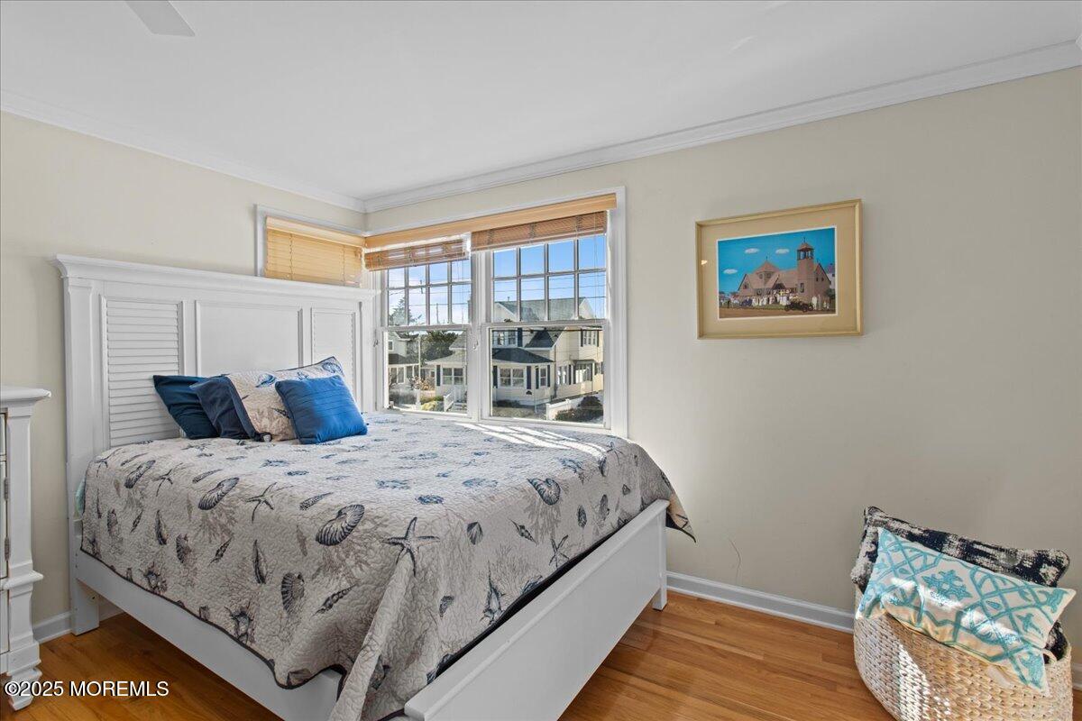 262 Sunset Lane Mantoloking, NJ 08738 - Photo 27 of 45 a bedroom with bed and wooden floor