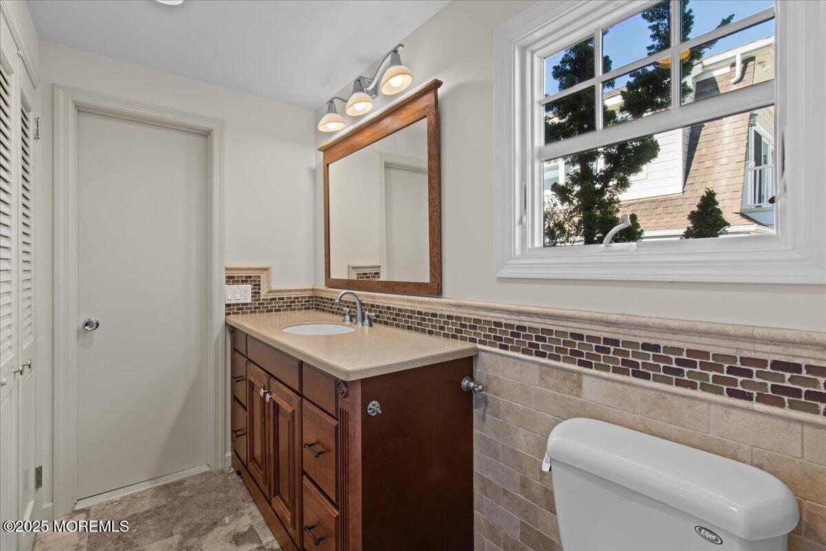 262 Sunset Lane Mantoloking, NJ 08738 - Photo 29 of 45 a bathroom with a toilet a sink and a mirror