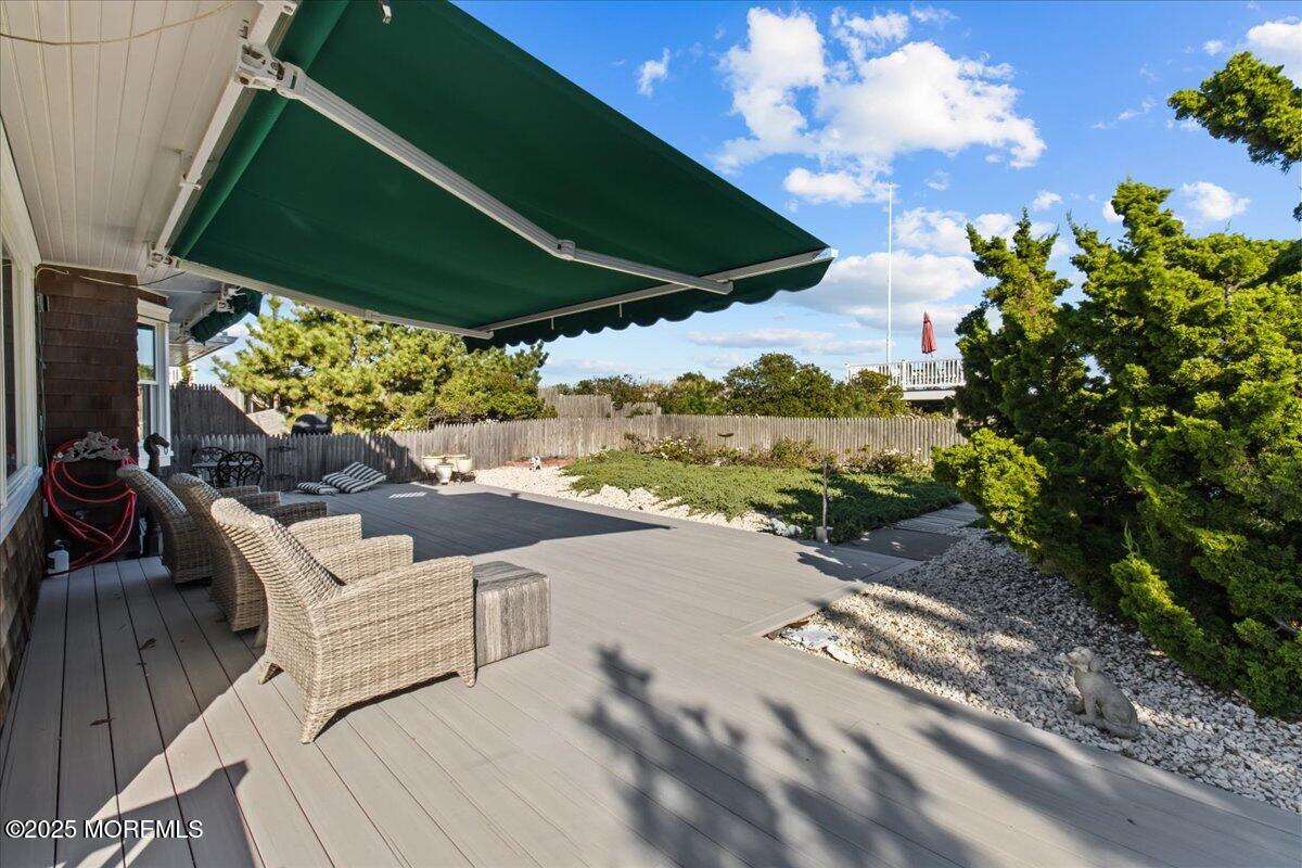262 Sunset Lane Mantoloking, NJ 08738 - Photo 3 of 45 a view of a patio with table and chairs under an umbrella