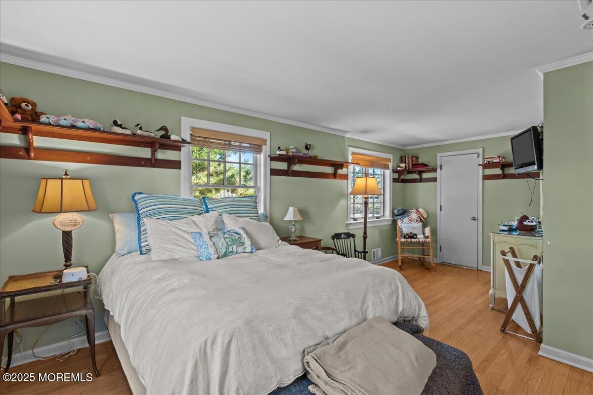 262 Sunset Lane Mantoloking, NJ 08738 - Photo 33 of 45 a bedroom with a bed and a lamp