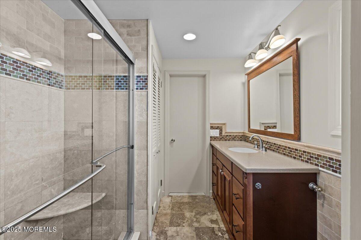 262 Sunset Lane Mantoloking, NJ 08738 - Photo 34 of 45 a bathroom with a double vanity sink and a mirror