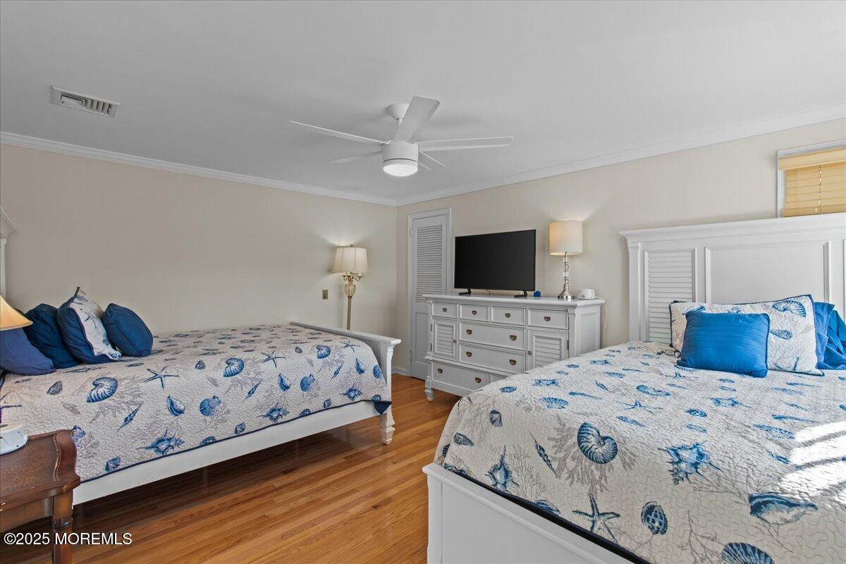 262 Sunset Lane Mantoloking, NJ 08738 - Photo 35 of 45 a bedroom with a bed and a flat screen tv