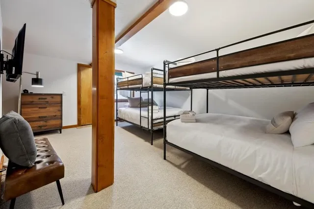 a bathroom with a granite countertop toilet a sink and a mirror
