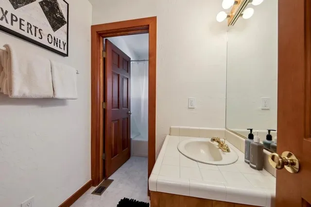 a bedroom with a bed and a night stand