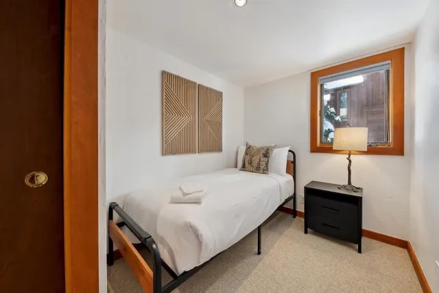 a hallway with a large window and couch