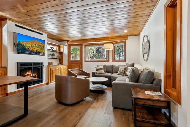 a living room with furniture a large window and a fireplace