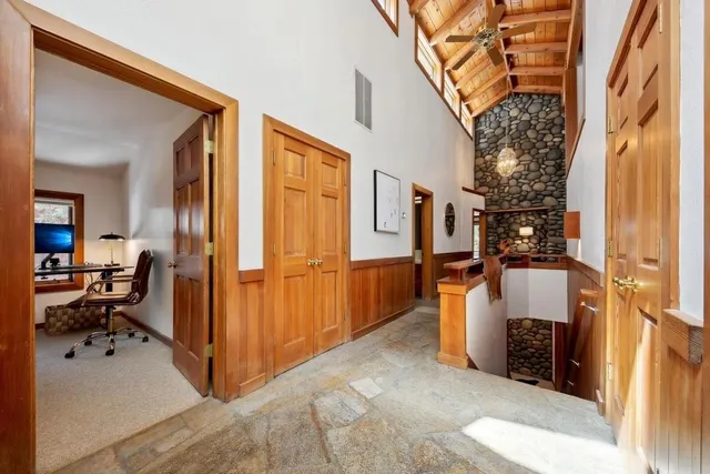 a large kitchen with stainless steel appliances granite countertop a large counter top space a stove and a refrigerator