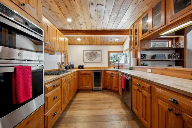 a kitchen with stainless steel appliances granite countertop a stove and cabinets