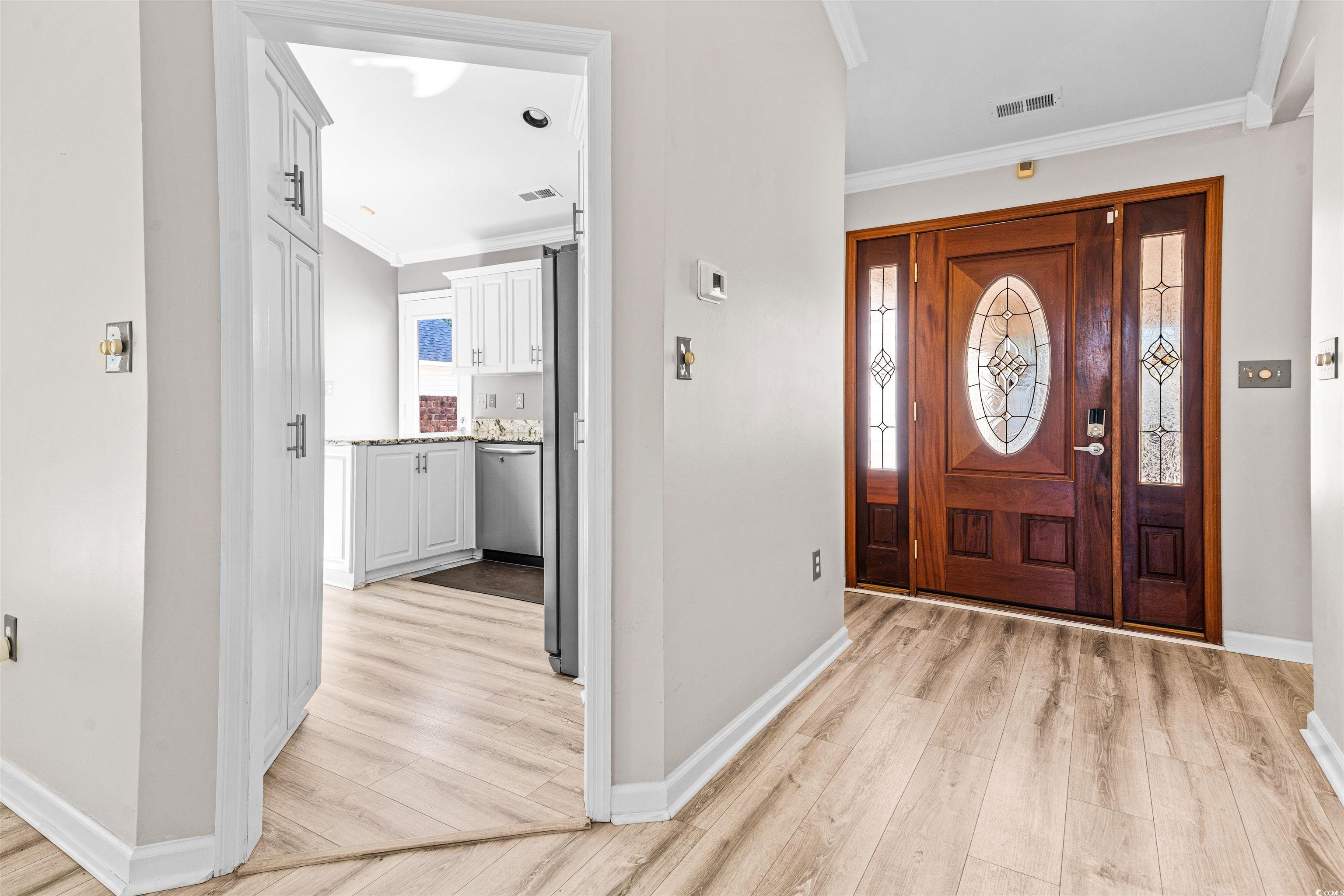 366 Pilothouse Drive Myrtle Beach, SC 29577 - Photo 6 of 40 Entryway featuring crown molding and light hardwoo