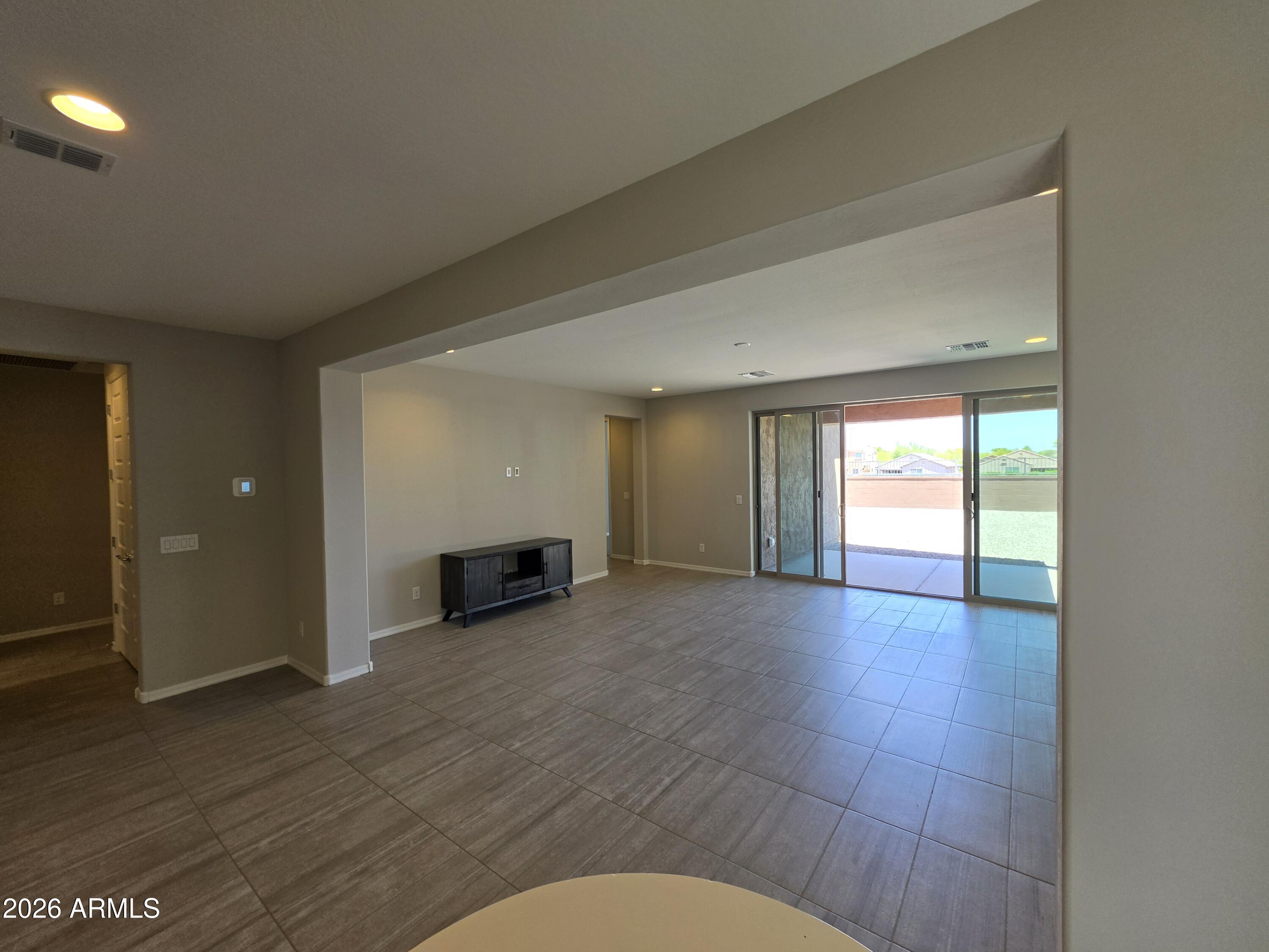 7128 West Coles Road Laveen, AZ 85339 - Photo 6 of 38 an empty room with wooden floor and windows