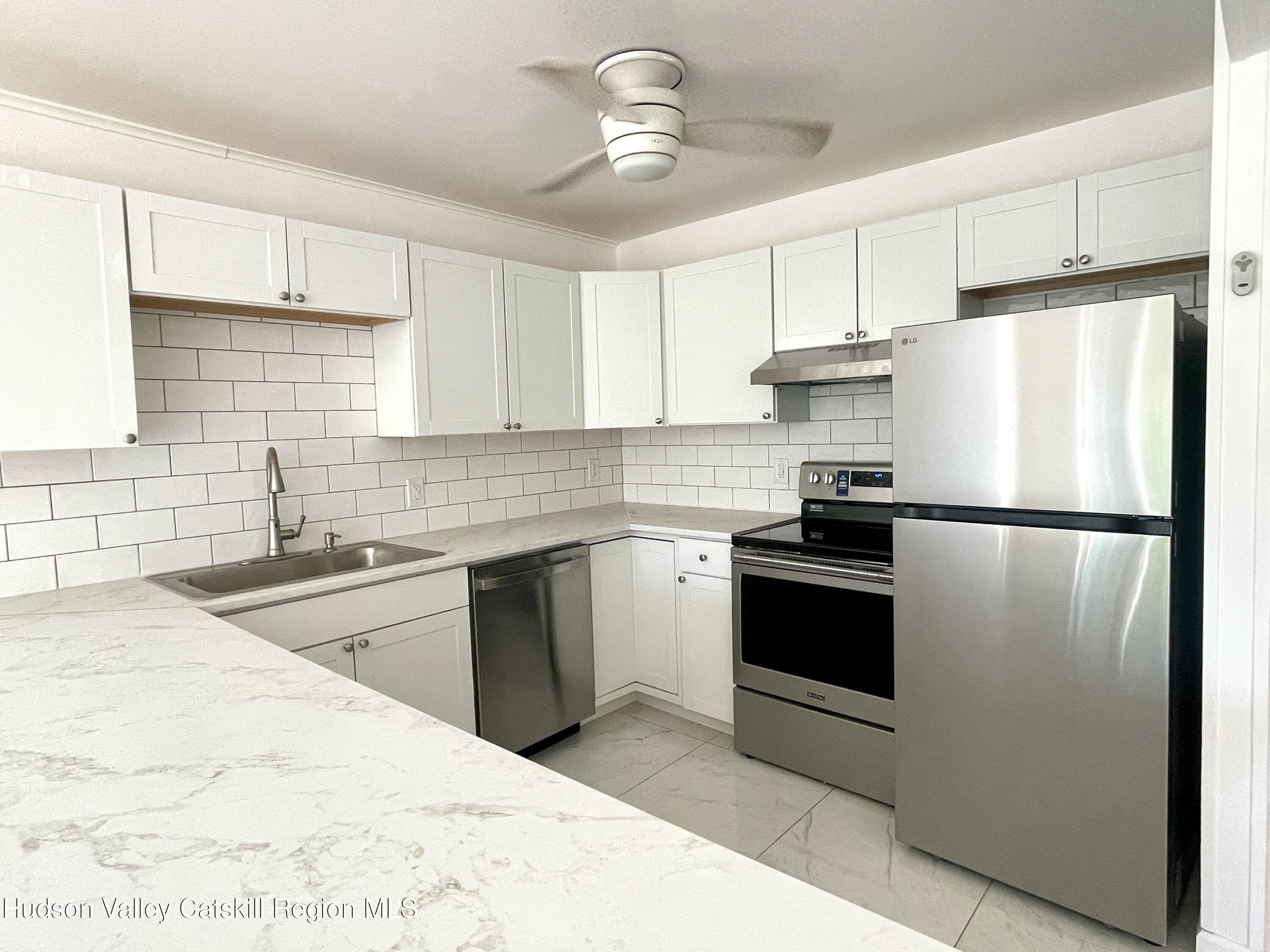 720 Warren Street, Unit 7 Hudson, NY 12534 - Photo 7 of 10 a kitchen with a refrigerator sink and cabinets