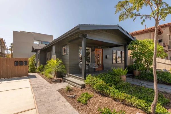 a front view of a house with a garden