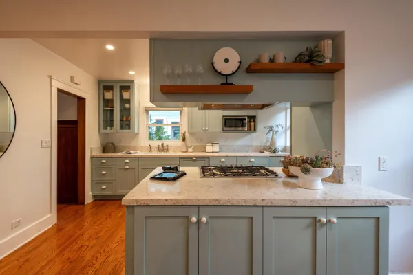 a kitchen with stainless steel appliances granite countertop a sink and a stove