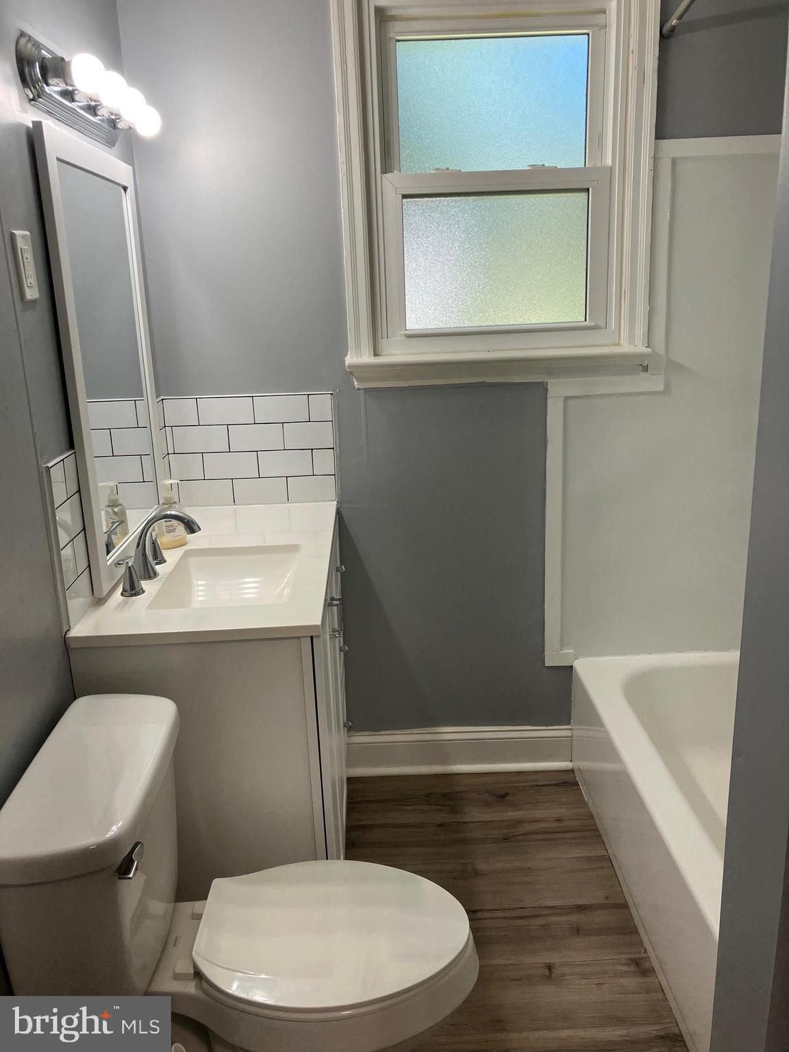 928 Pemberton - Browns Mills Road Pemberton, NJ 08068 - Photo 6 of 10 a bathroom with a sink a toilet a mirror and bathtub