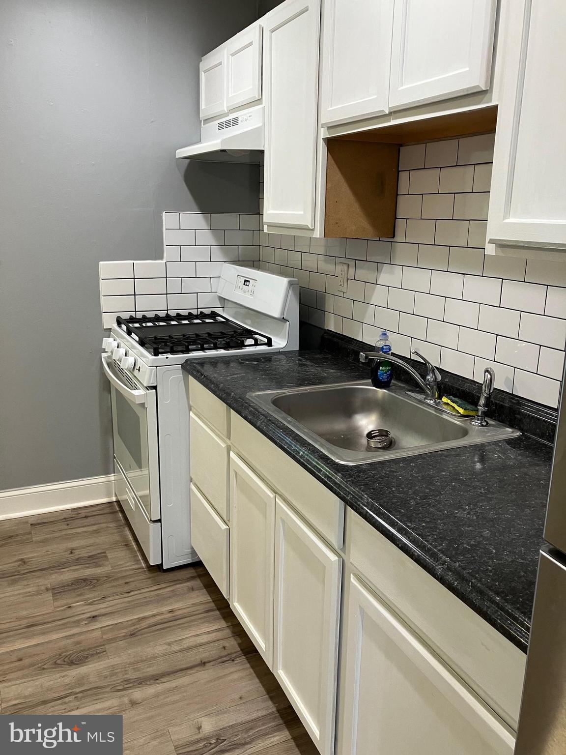 928 Pemberton - Browns Mills Road Pemberton, NJ 08068 - Photo 10 of 10 a kitchen with granite countertop a stove sink and cabinets