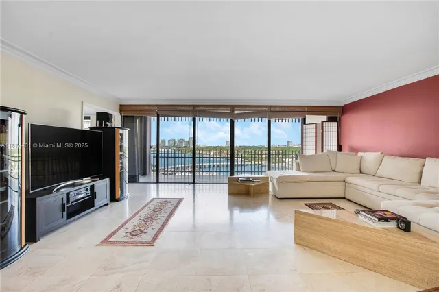 a living room with furniture a flat screen tv and a floor to ceiling window
