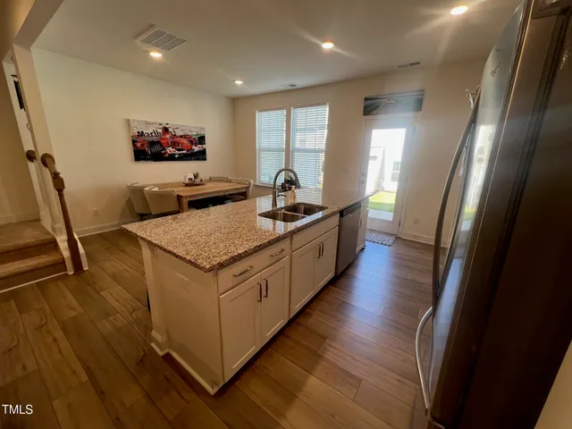 a kitchen with granite countertop a stove and a sink