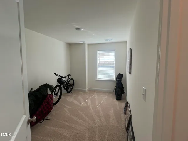 a room with two beds and a window