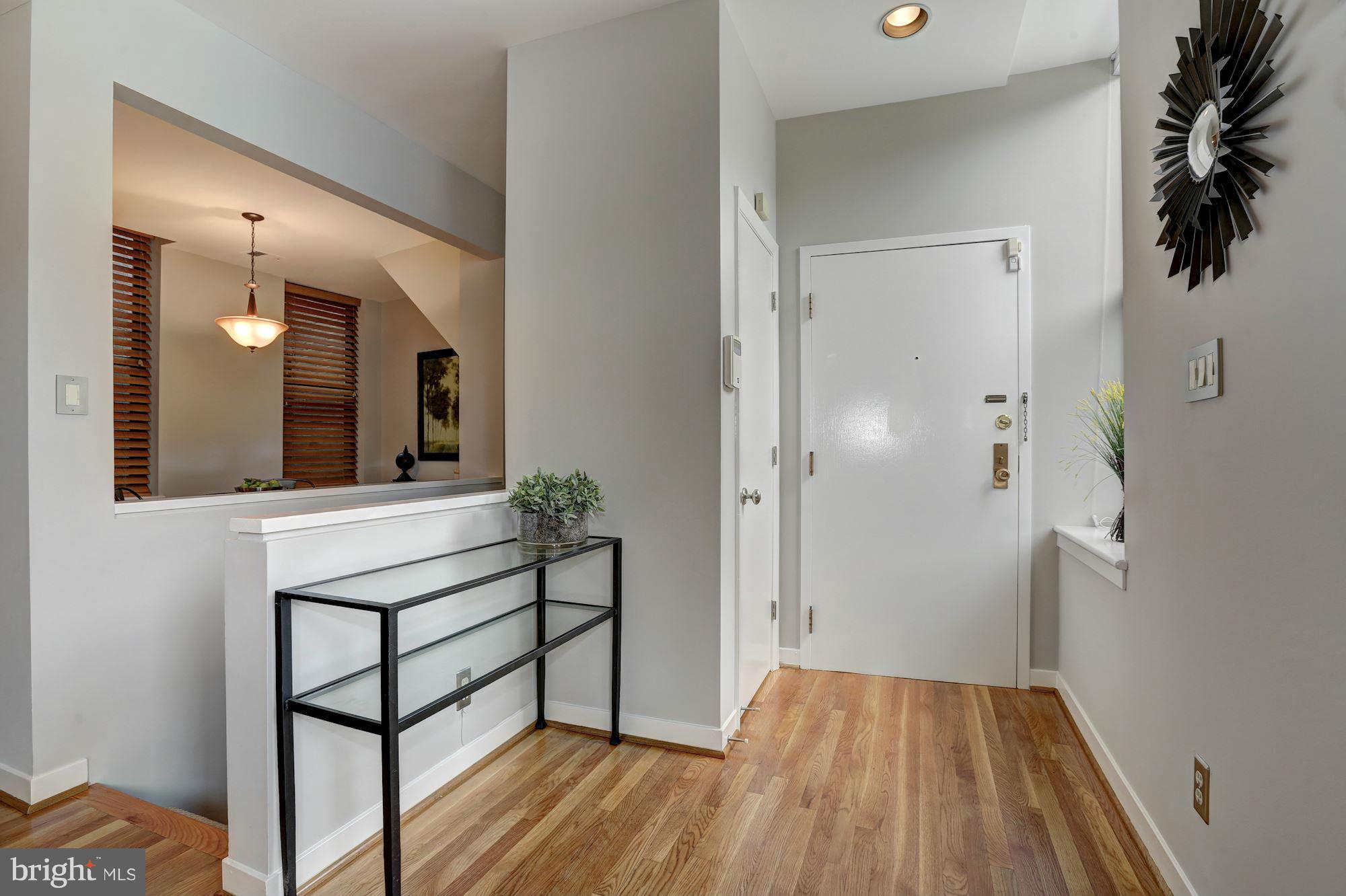 3 Washington Circle Northwest, Unit 103 Washington, DC 20037 - Photo 13 of 28 a view of a hallway and wooden floor and a bathroom