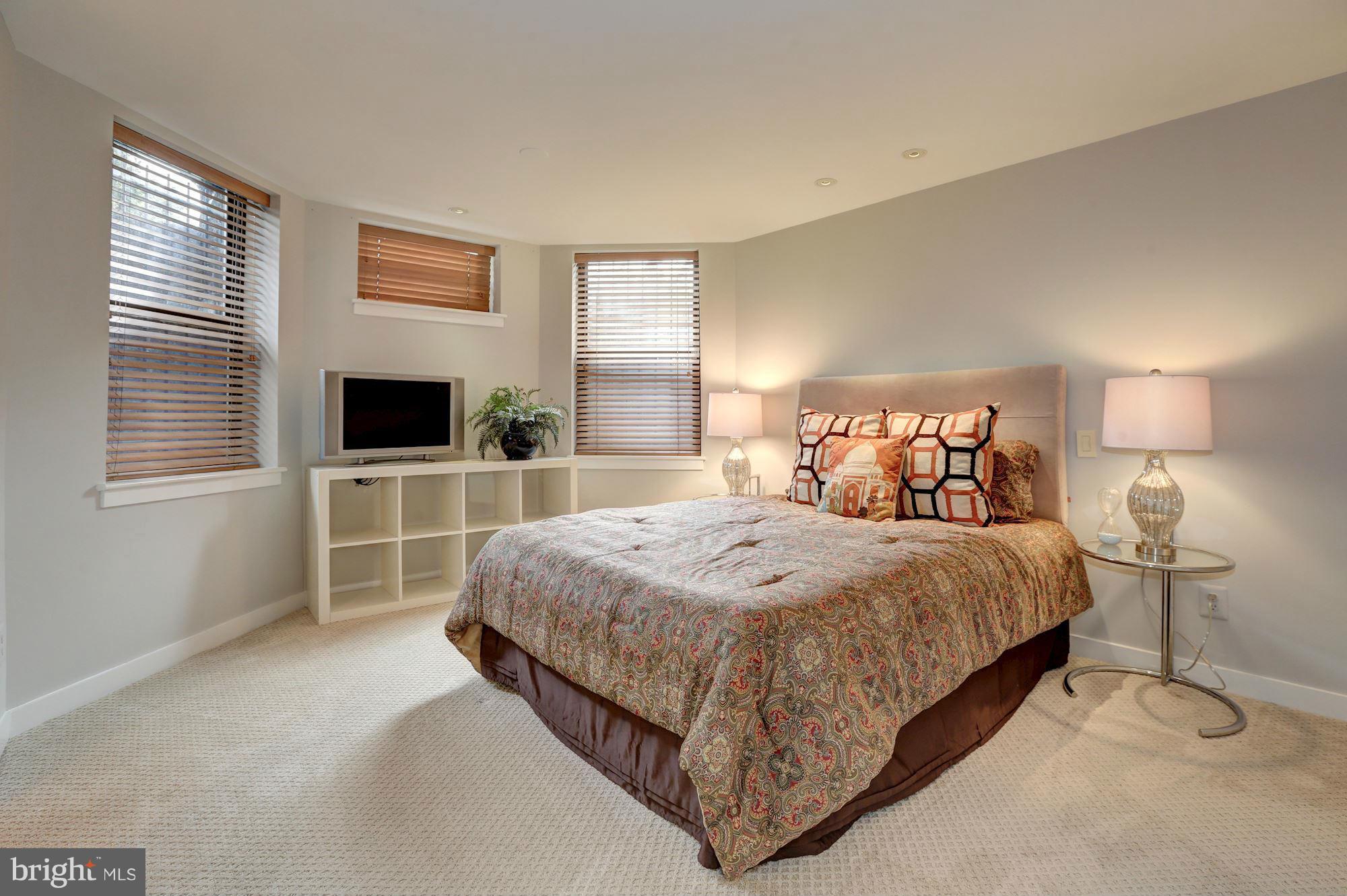 3 Washington Circle Northwest, Unit 103 Washington, DC 20037 - Photo 14 of 28 a bedroom with a bed and a flat screen tv