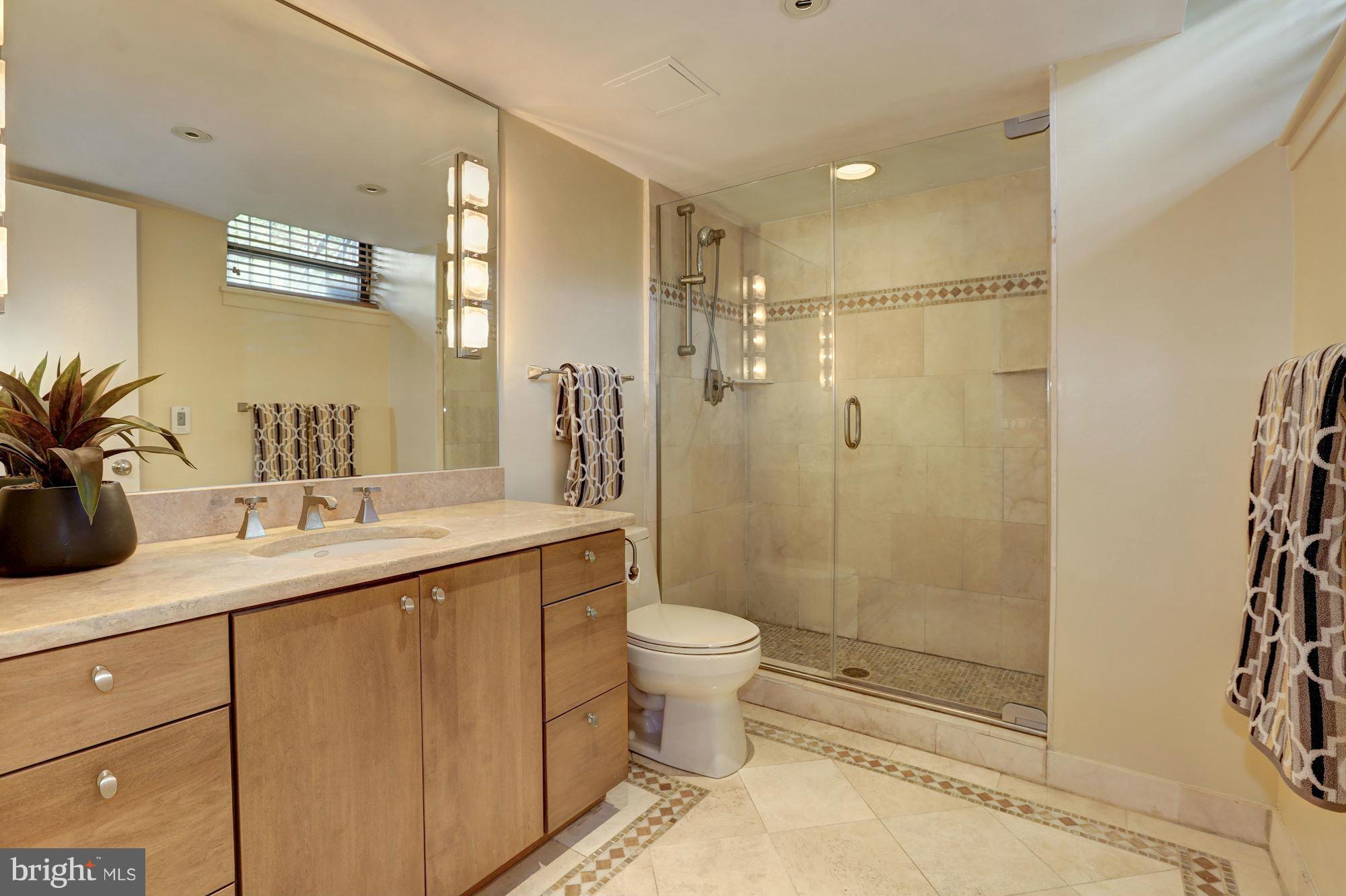 3 Washington Circle Northwest, Unit 103 Washington, DC 20037 - Photo 16 of 28 a bathroom with a sink toilet and shower