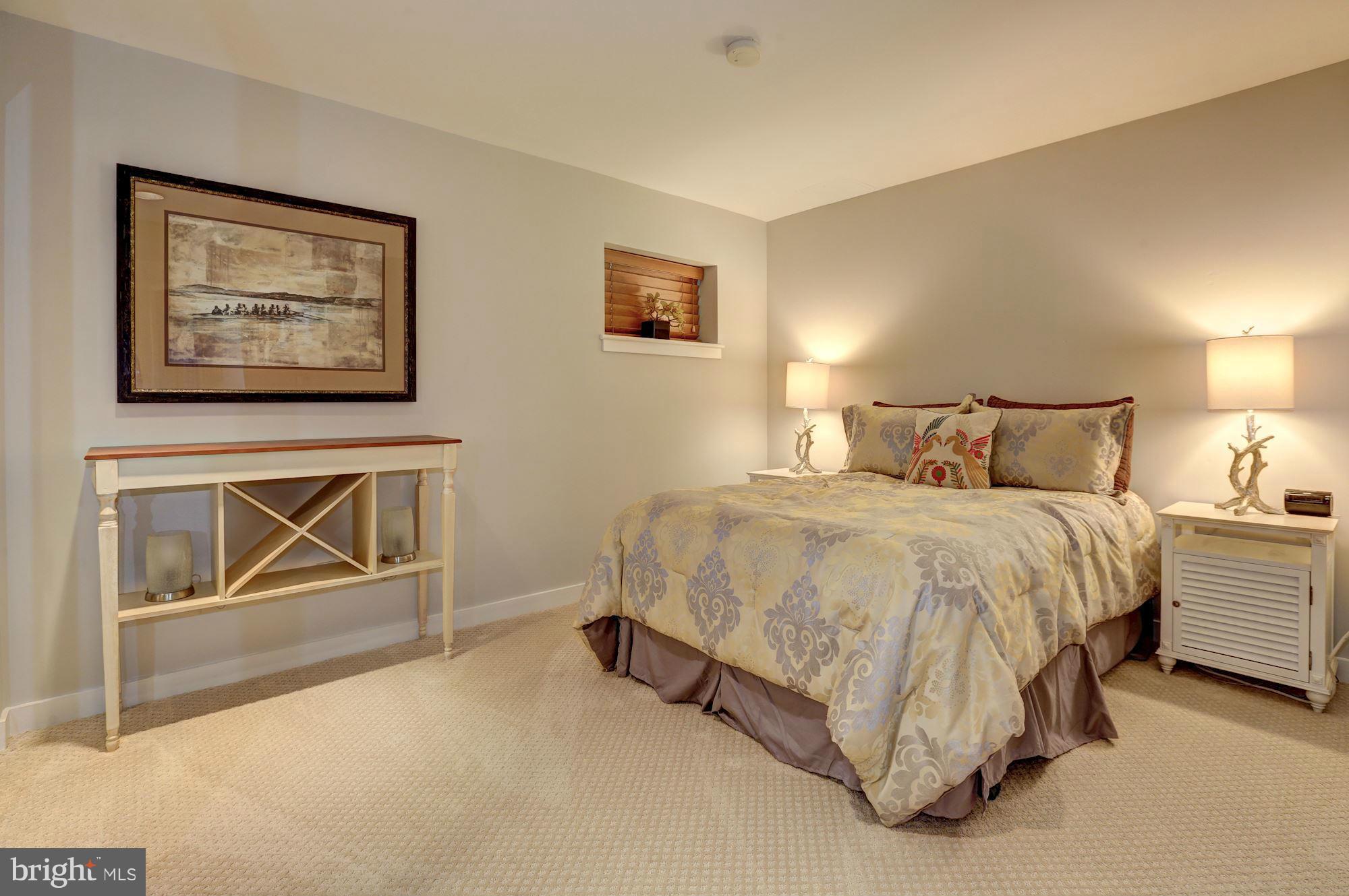 3 Washington Circle Northwest, Unit 103 Washington, DC 20037 - Photo 17 of 28 a spacious bedroom with a bed and glass windows