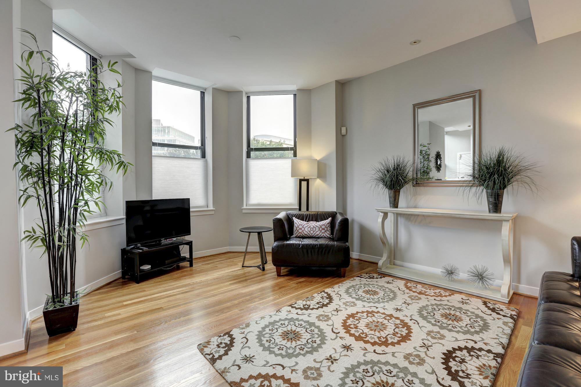 3 Washington Circle Northwest, Unit 103 Washington, DC 20037 - Photo 4 of 28 a living room with furniture and a flat screen tv