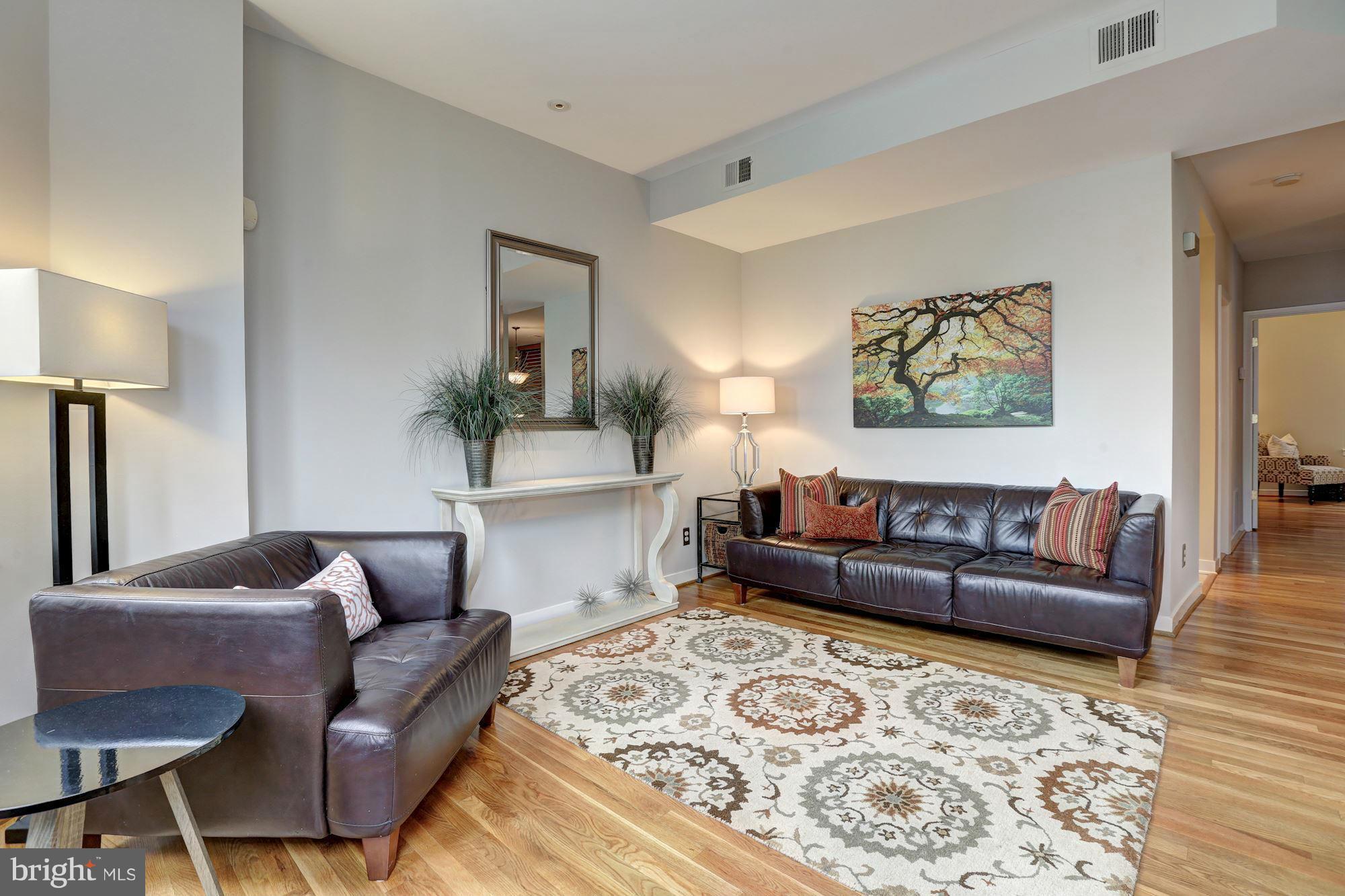 3 Washington Circle Northwest, Unit 103 Washington, DC 20037 - Photo 5 of 28 a living room with furniture and painting on the wall