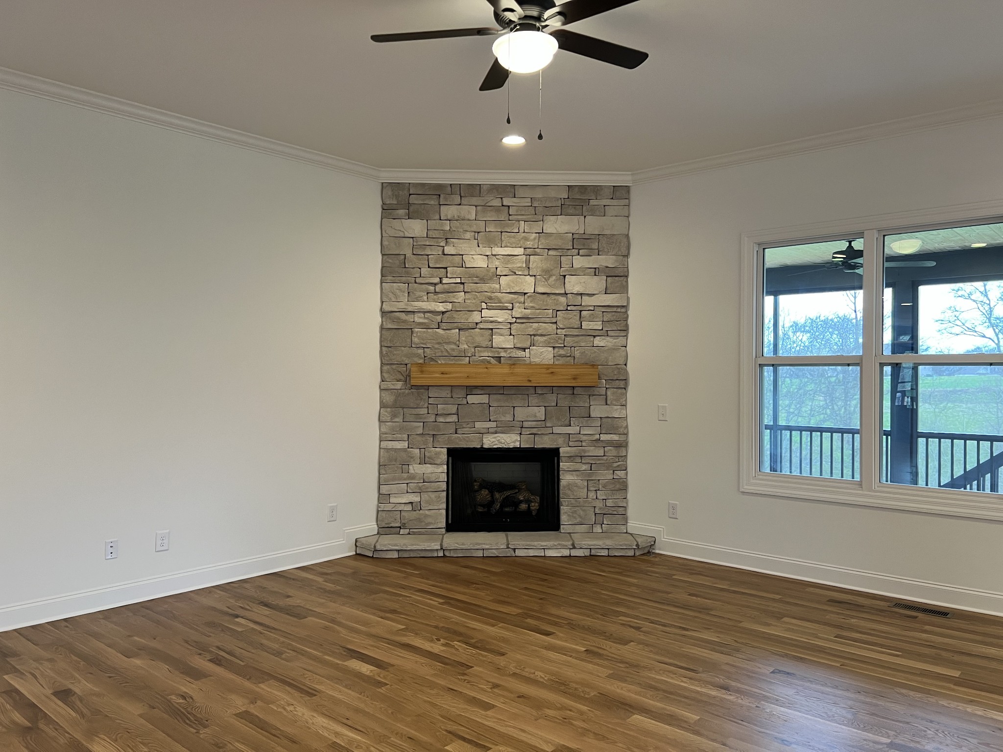 1055 Hideaway Road Columbia, TN 38401 - Photo 3 of 15 a view of an empty room with wooden floor fireplace and a window