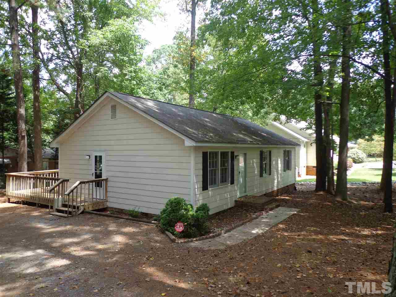 3616 Lynn Road Raleigh, NC 27613 - Photo 1 of 12 a view of a house with a yard and sitting area