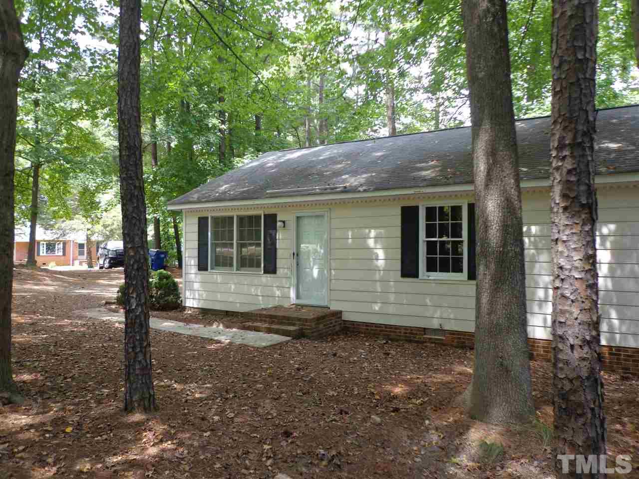3616 Lynn Road Raleigh, NC 27613 - Photo 4 of 12 a front view of a house with a garden