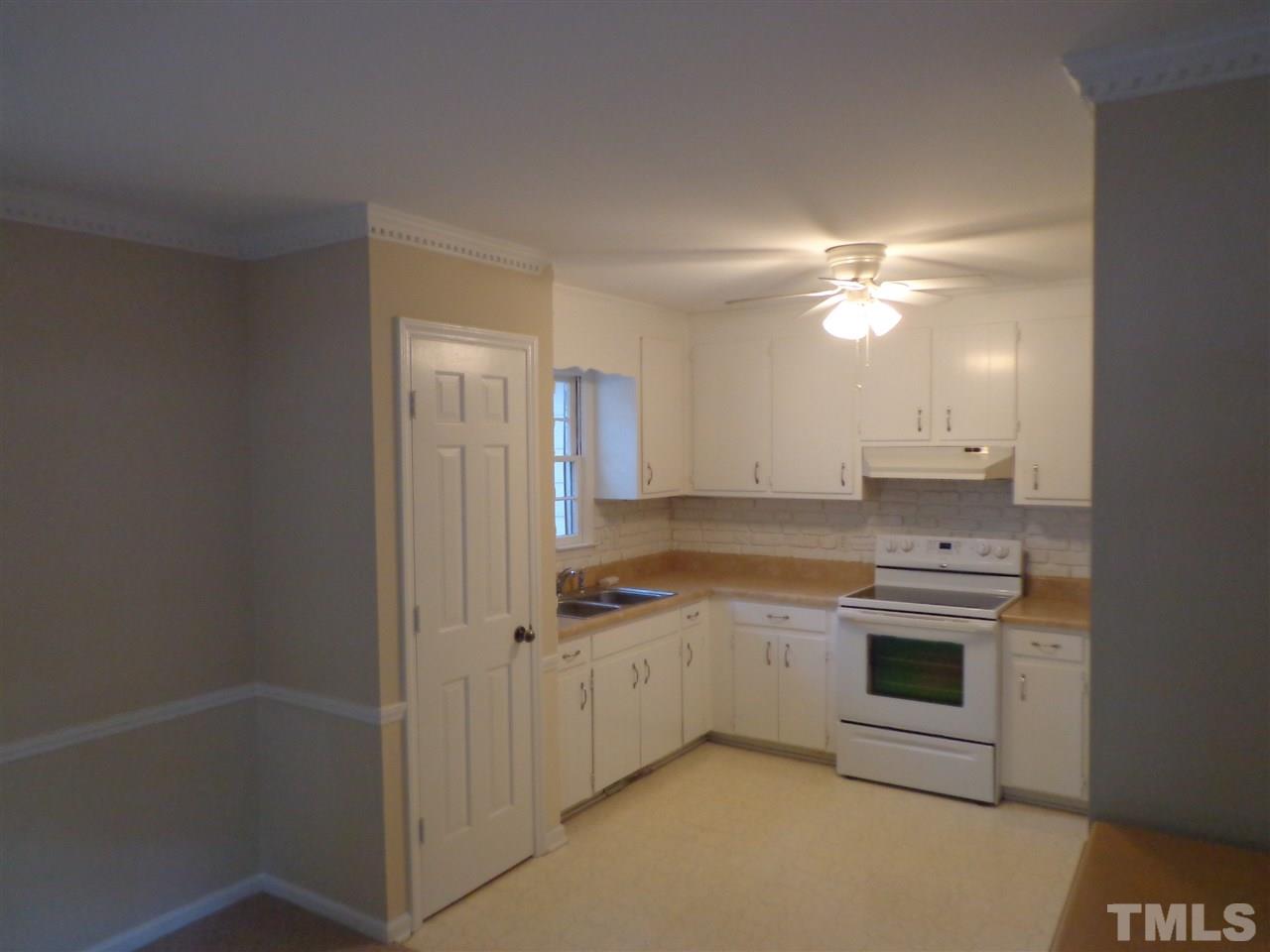 3616 Lynn Road Raleigh, NC 27613 - Photo 6 of 12 a kitchen with a sink stove and cabinets