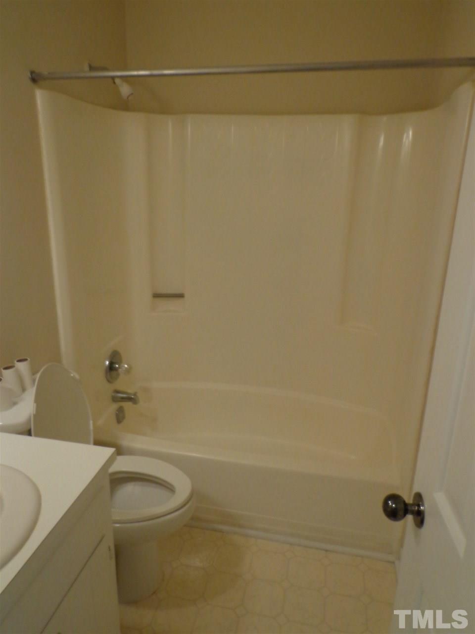 3616 Lynn Road Raleigh, NC 27613 - Photo 8 of 12 a bathroom with a shower a toilet and a sink