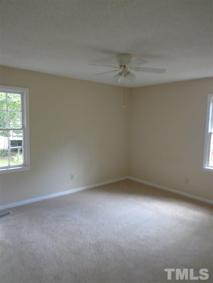 3616 Lynn Road Raleigh, NC 27613 - Photo 10 of 12 an empty room with a window and a fan