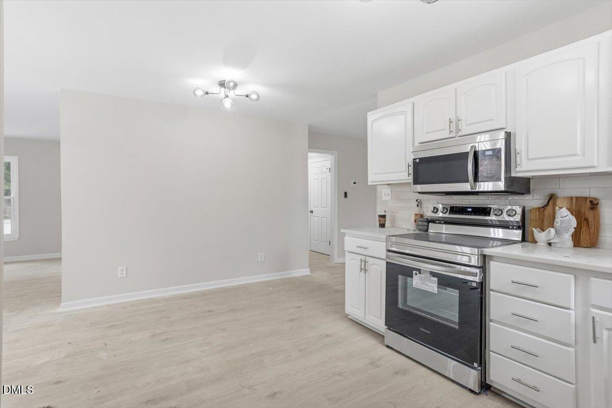 3457 Hope Valley Road Durham, NC 27707 - Photo 10 of 24 a view of a kitchen with stove and microwave