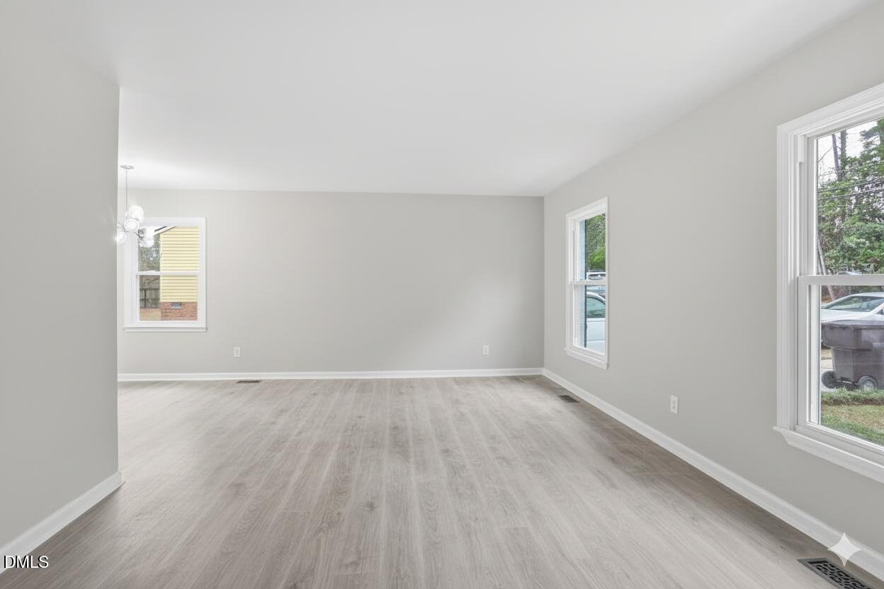 3457 Hope Valley Road Durham, NC 27707 - Photo 14 of 24 an empty room with wooden floor and windows
