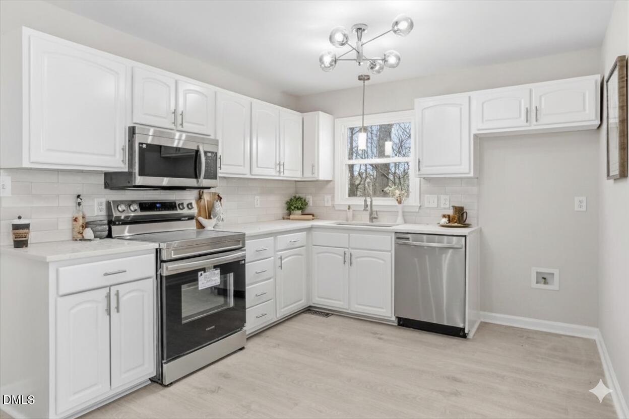 3457 Hope Valley Road Durham, NC 27707 - Photo 2 of 24 a kitchen with white cabinets and white appliances