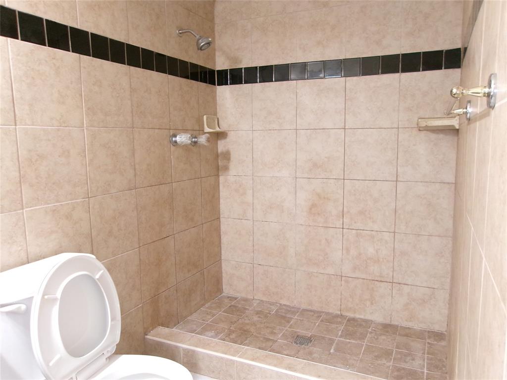 1201 Independence Trail Grand Prairie, TX 75052 - Photo 16 of 24 a bathroom with a toilet and a shower