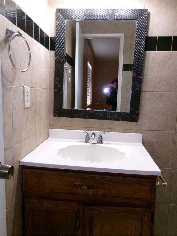 1201 Independence Trail Grand Prairie, TX 75052 - Photo 17 of 24 a bathroom with a sink and a mirror