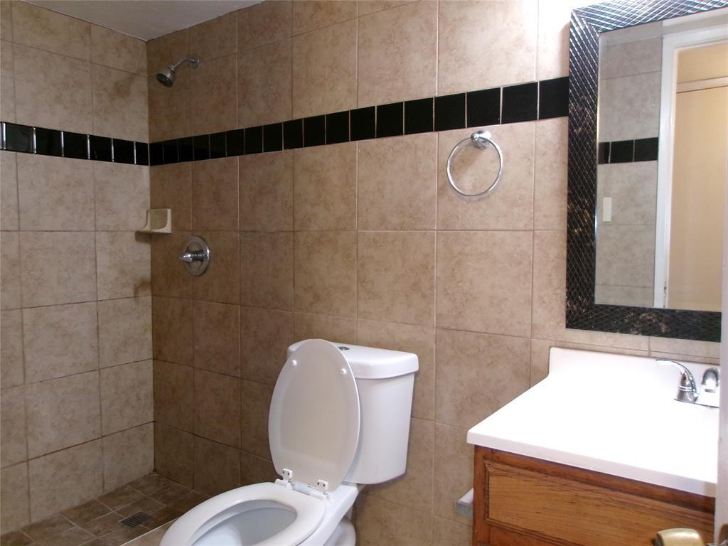 1201 Independence Trail Grand Prairie, TX 75052 - Photo 18 of 24 a bathroom with a sink a toilet and shower