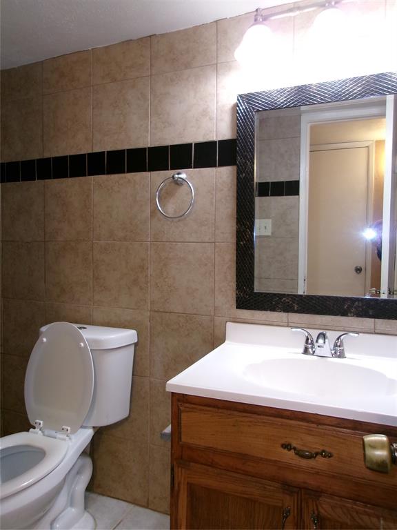 1201 Independence Trail Grand Prairie, TX 75052 - Photo 19 of 24 a bathroom with a sink mirror vanity and toilet