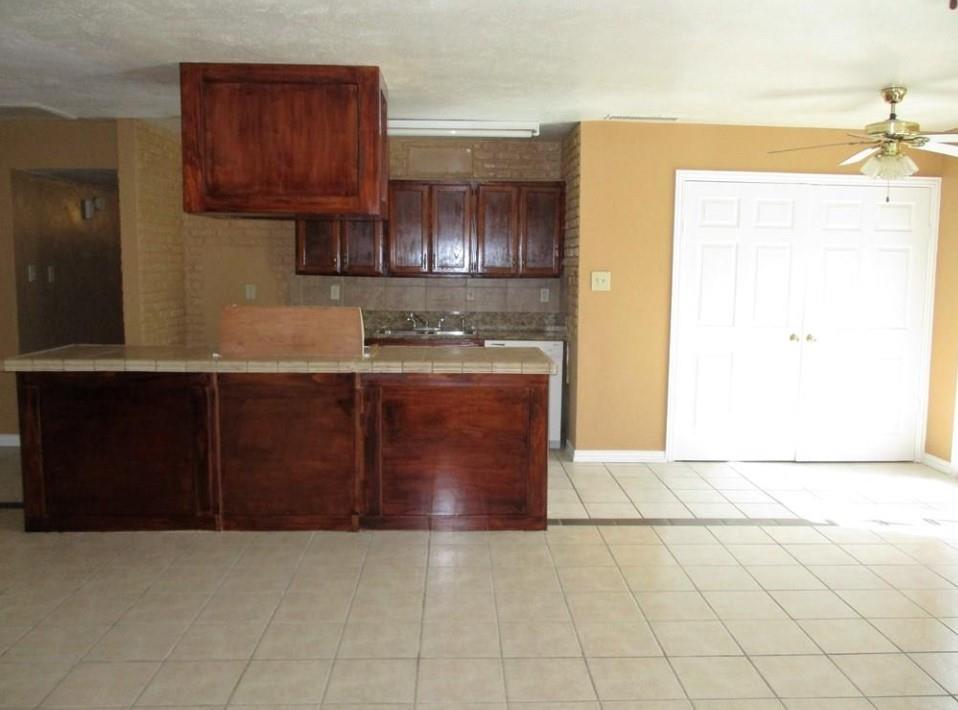 1201 Independence Trail Grand Prairie, TX 75052 - Photo 2 of 24 a kitchen with stainless steel appliances granite countertop a stove a sink and a microwave