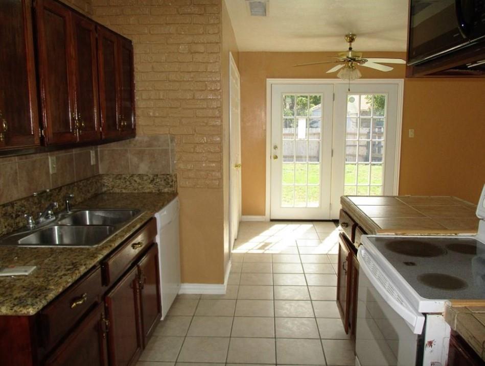 1201 Independence Trail Grand Prairie, TX 75052 - Photo 3 of 24 a kitchen that has a sink and a stove