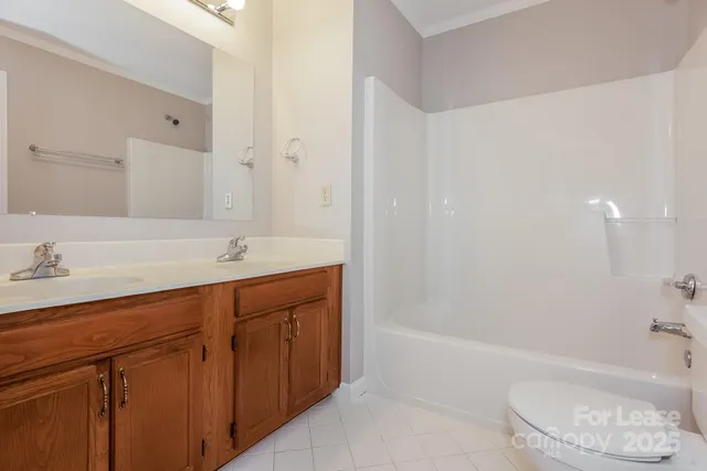 a bathroom with a bathtub shower sink and toilet