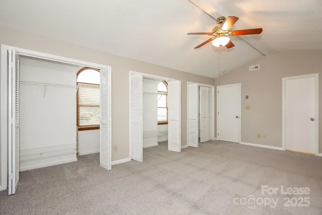 wooden floor in an empty room with a ceiling fan
