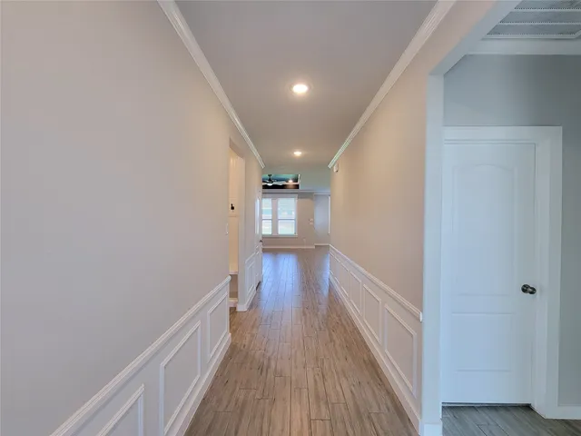 a view of a hallway with wooden floor